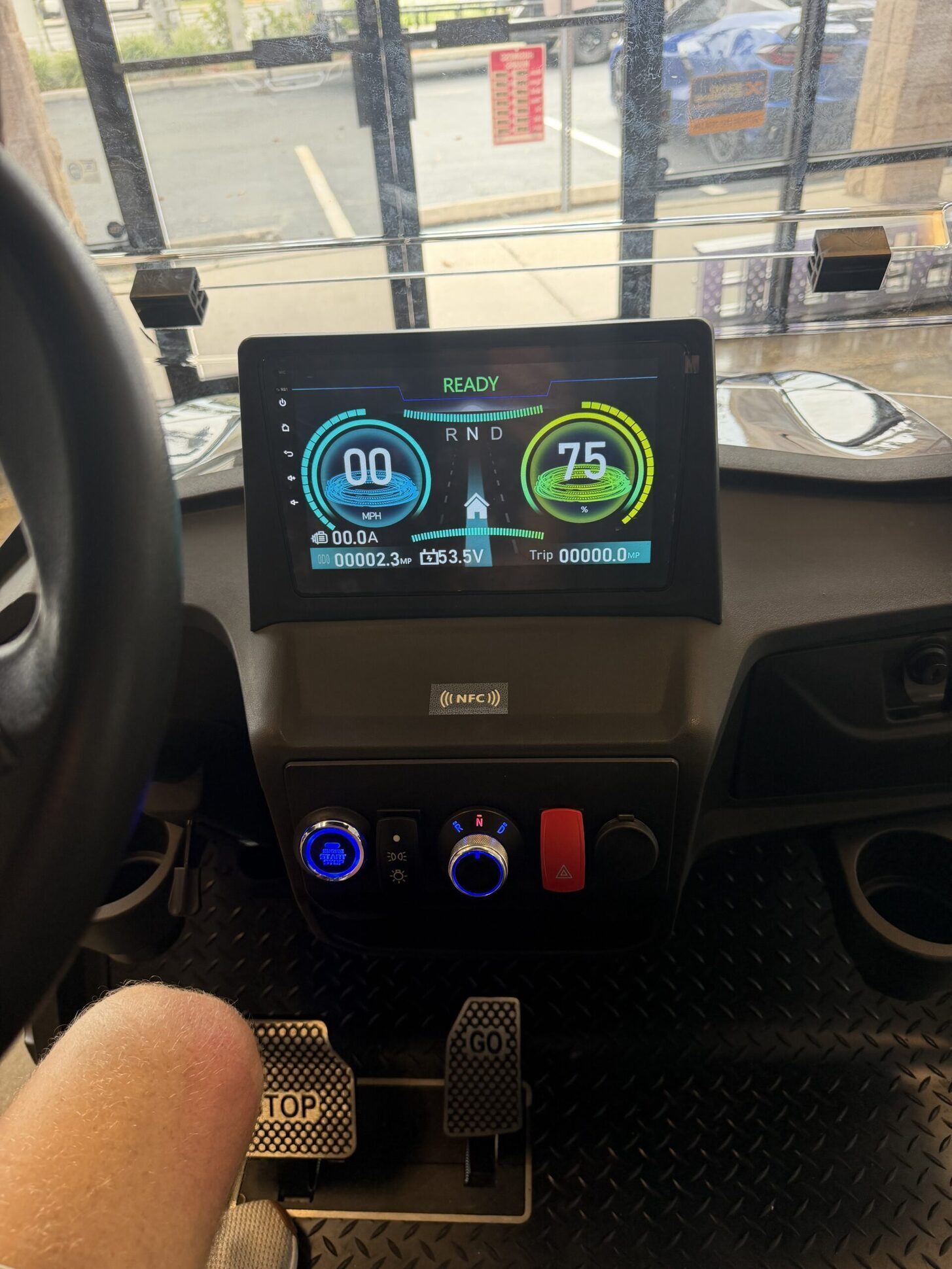 Lit golf cart touchscreen dashboard.